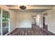Open living room featuring wood-look floors, sliding glass door, and abundant natural light creating a cozy atmosphere at 7719 Grandview Dr, Indianapolis, IN 46260