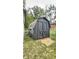 A spacious, dark painted backyard shed with double doors offers practical storage with a classic design to compliment your yard at 7719 Grandview Dr, Indianapolis, IN 46260