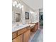 Bright bathroom with a double vanity, a large mirror, and a walk-in shower at 7850 King Post Dr, Indianapolis, IN 46237