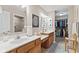 Bathroom featuring double sinks, updated fixtures, and access to a walk-in closet, designed for convenience and style at 7850 King Post Dr, Indianapolis, IN 46237