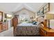 Well-lit bedroom with vaulted ceilings, a large window, wood furniture, and tasteful decor, creating a peaceful retreat at 7850 King Post Dr, Indianapolis, IN 46237