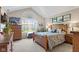 Cozy bedroom with vaulted ceiling, a large window, and warm, neutral tones at 7850 King Post Dr, Indianapolis, IN 46237