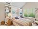 Cozy bedroom with vaulted ceiling, built-in shelving, and a comfortable bed with colorful bedding at 7850 King Post Dr, Indianapolis, IN 46237