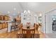 Bright dining room featuring a wooden table, chairs, and hardwood floors, with an open view of the kitchen at 7850 King Post Dr, Indianapolis, IN 46237