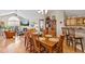 Open concept dining room with hardwood floors, a vaulted ceiling, and an adjacent living space with a fireplace at 7850 King Post Dr, Indianapolis, IN 46237