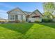 Charming home exterior with manicured lawn and a mix of stone and siding, enhancing its curb appeal at 7850 King Post Dr, Indianapolis, IN 46237