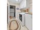 Organized laundry room with white cabinets, granite countertop, and washer/dryer at 7850 King Post Dr, Indianapolis, IN 46237