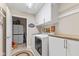 Well-organized laundry room with white cabinets, countertop, and washer-dryer at 7850 King Post Dr, Indianapolis, IN 46237
