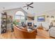 Stylish living room featuring hardwood floors, vaulted ceiling, and a fireplace, creating a cozy and inviting atmosphere at 7850 King Post Dr, Indianapolis, IN 46237