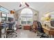 Bright office space featuring vaulted ceilings, neutral paint, multiple work areas, and a large arched window with views of the outdoors at 7850 King Post Dr, Indianapolis, IN 46237