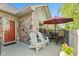 Inviting patio area with stone accents, featuring comfortable seating and a shade umbrella at 7850 King Post Dr, Indianapolis, IN 46237