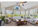 Bright sunroom with large windows, comfortable seating, and views of the garden at 7850 King Post Dr, Indianapolis, IN 46237