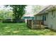 Backyard featuring a green lawn, wooden deck and wooden fence at 7966 Chiltern Dr, Indianapolis, IN 46268
