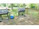 Wooden deck with two grills and wooded scenery at 7966 Chiltern Dr, Indianapolis, IN 46268