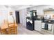 Well-lit kitchen with gray cabinets, stainless steel appliances, and an adjacent dining area for convenient meal preparation at 7966 Chiltern Dr, Indianapolis, IN 46268