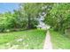 Spacious backyard with green grass and a concrete walkway at 806 N Gray St, Indianapolis, IN 46201