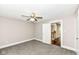 Bright bedroom featuring a ceiling fan, soft carpet, and doorway to another room at 806 N Gray St, Indianapolis, IN 46201