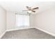 Neutral bedroom featuring a ceiling fan, soft carpet and sheer curtains at 806 N Gray St, Indianapolis, IN 46201