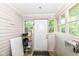 Enclosed back porch acts as functional mud room with windows and backyard views at 806 N Gray St, Indianapolis, IN 46201