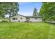 Spacious backyard with a well-maintained lawn and charming white brick exterior, perfect for outdoor activities at 8105 Allisonville Rd, Indianapolis, IN 46250