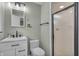 Bathroom featuring a modern vanity, toilet, framed mirror, and shower with glass doors at 8105 Allisonville Rd, Indianapolis, IN 46250