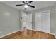 A spacious bedroom featuring hardwood floors, closet space, and freshly painted walls at 8105 Allisonville Rd, Indianapolis, IN 46250