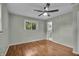 A brightly lit bedroom with hardwood floors, large windows, and fresh paint at 8105 Allisonville Rd, Indianapolis, IN 46250