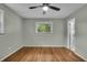 A bright bedroom features hardwood floors, a window, and easy access to an ensuite bathroom at 8105 Allisonville Rd, Indianapolis, IN 46250