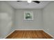 Bright bedroom featuring beautiful hardwood floors, a window, and neutral paint scheme at 8105 Allisonville Rd, Indianapolis, IN 46250