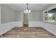 Bright dining room with wood-look floors and a traditional-style hanging light fixture at 8105 Allisonville Rd, Indianapolis, IN 46250