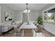 Light filled dining room features a modern chandelier and a stylish marble-top table at 8105 Allisonville Rd, Indianapolis, IN 46250