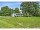 Charming single-story home with white brick, lush green lawn, and mature trees, enhancing curb appeal at 8105 Allisonville Rd, Indianapolis, IN 46250