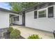 Inviting covered entrance with white brick, black trim, a freshly landscaped front yard and upgraded front door at 8105 Allisonville Rd, Indianapolis, IN 46250