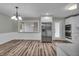 Open kitchen and dining area with stainless fridge, oven and white cabinets at 8105 Allisonville Rd, Indianapolis, IN 46250