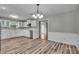 Open concept kitchen features white cabinets, stainless appliances, and wood-look flooring at 8105 Allisonville Rd, Indianapolis, IN 46250
