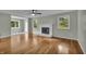 Bright and open living room with hardwood flooring, neutral paint, a fireplace, and lots of natural light at 8105 Allisonville Rd, Indianapolis, IN 46250