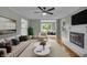 Bright and airy living room with a fireplace, neutral paint, large windows, and hardwood floors at 8105 Allisonville Rd, Indianapolis, IN 46250