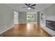 Bright living room with hardwood floors, neutral color palette, fireplace, and open flow to the kitchen at 8105 Allisonville Rd, Indianapolis, IN 46250