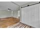 Bright living room featuring ceiling fan, and sliding barn door to the bedroom at 8105 Allisonville Rd, Indianapolis, IN 46250