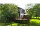 Expansive backyard view featuring a spacious deck with patio furniture and lush greenery at 8394 Glen Highlands Dr, Indianapolis, IN 46236