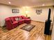 Finished basement with a cozy red sectional couch and a decorative rug at 8394 Glen Highlands Dr, Indianapolis, IN 46236