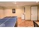 Basement game room featuring a ping pong table, a mini fridge, and ample space for entertainment at 8394 Glen Highlands Dr, Indianapolis, IN 46236