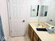 Bathroom features a double vanity sink, a large mirror, and a tile floor at 8394 Glen Highlands Dr, Indianapolis, IN 46236
