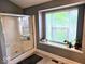 Bright bathroom featuring a glass shower and natural light from window at 8394 Glen Highlands Dr, Indianapolis, IN 46236