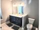 Bathroom featuring double vanity, framed mirrors, and ceramic tile floor at 8394 Glen Highlands Dr, Indianapolis, IN 46236