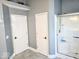 Bathroom featuring a glass shower and two entry doors at 8394 Glen Highlands Dr, Indianapolis, IN 46236
