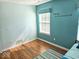 Comfortable bedroom featuring hardwood floors, natural light, and neutral color scheme at 8394 Glen Highlands Dr, Indianapolis, IN 46236