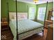 Green bedroom featuring natural light, hardwood floors and a full-sized bed frame at 8394 Glen Highlands Dr, Indianapolis, IN 46236