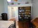 Bright bedroom featuring wood floors, a vaulted ceiling and a built-in bookshelf at 8394 Glen Highlands Dr, Indianapolis, IN 46236