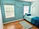 Cozy bedroom featuring hardwood floors, natural light, and neutral color scheme at 8394 Glen Highlands Dr, Indianapolis, IN 46236